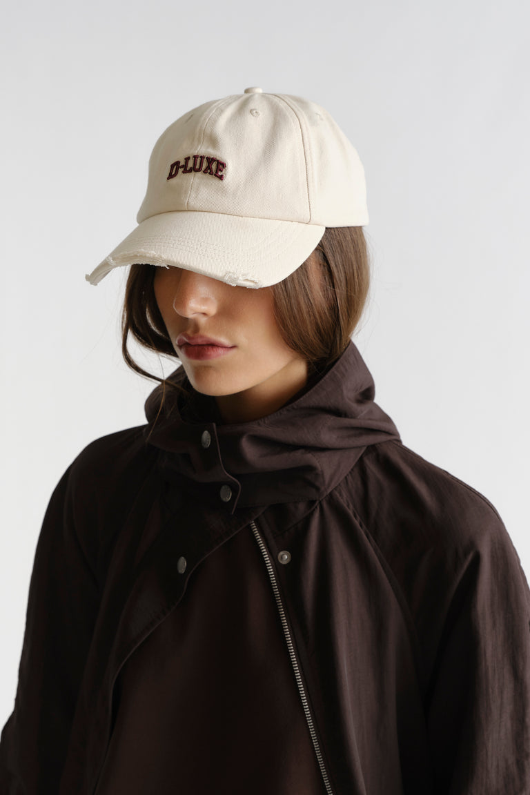 Woman wearing D-Luxe Lana Distressed Cap in 100% cotton with relaxed fit and embroidered logo by DECJUBA Australian fashion brand