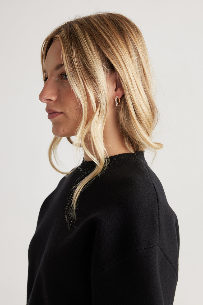 Side profile of a woman wearing gold hoop Cat Earring Multi Pack with textured detail, styled with loose blonde waves