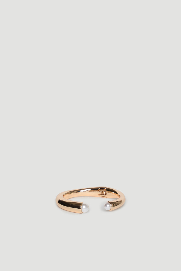 Gold open cuff bracelet featuring two delicate pearl accents at each end