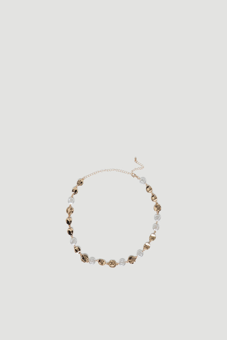 Delicate gold chain necklace featuring irregular molten-style links paired with clear bead accents for a modern look