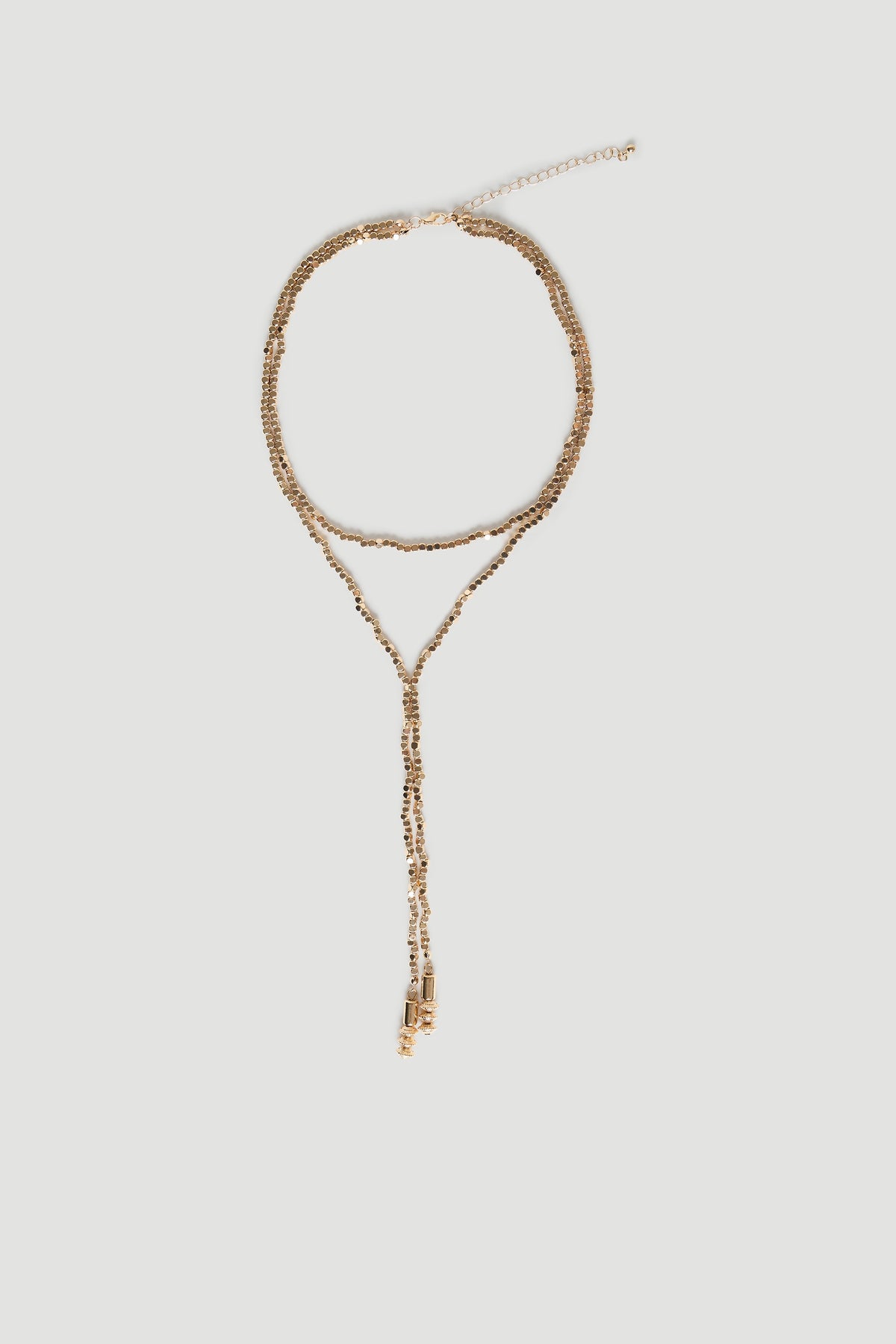 Delicate antique gold-tone lariat necklace with bead detailing and adjustable chain for elegant, versatile layering.