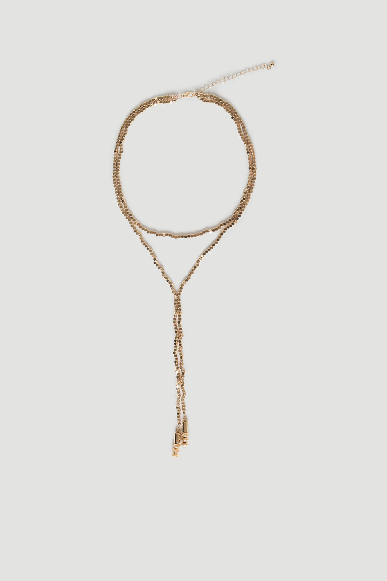 Delicate antique gold-tone lariat necklace with bead detailing and adjustable chain for elegant, versatile layering.