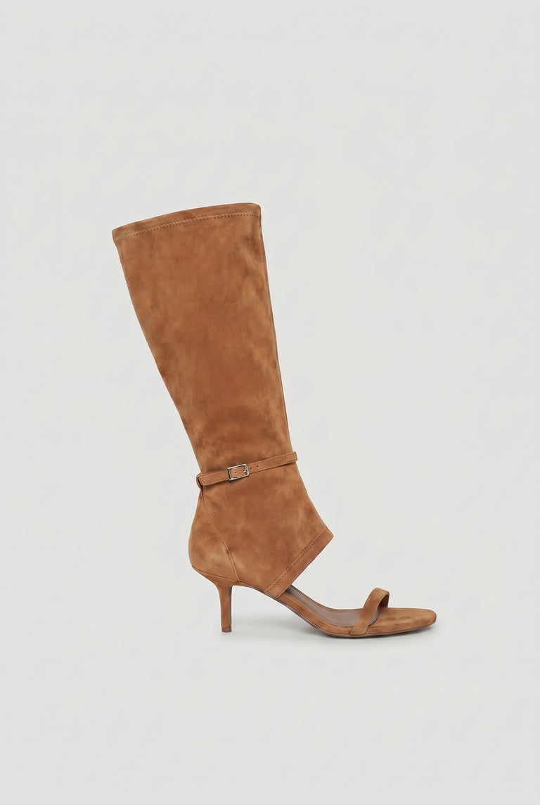Tan suede open-toe heel with a mid-height stiletto and a tall, fitted shaft featuring a delicate buckle strap.
