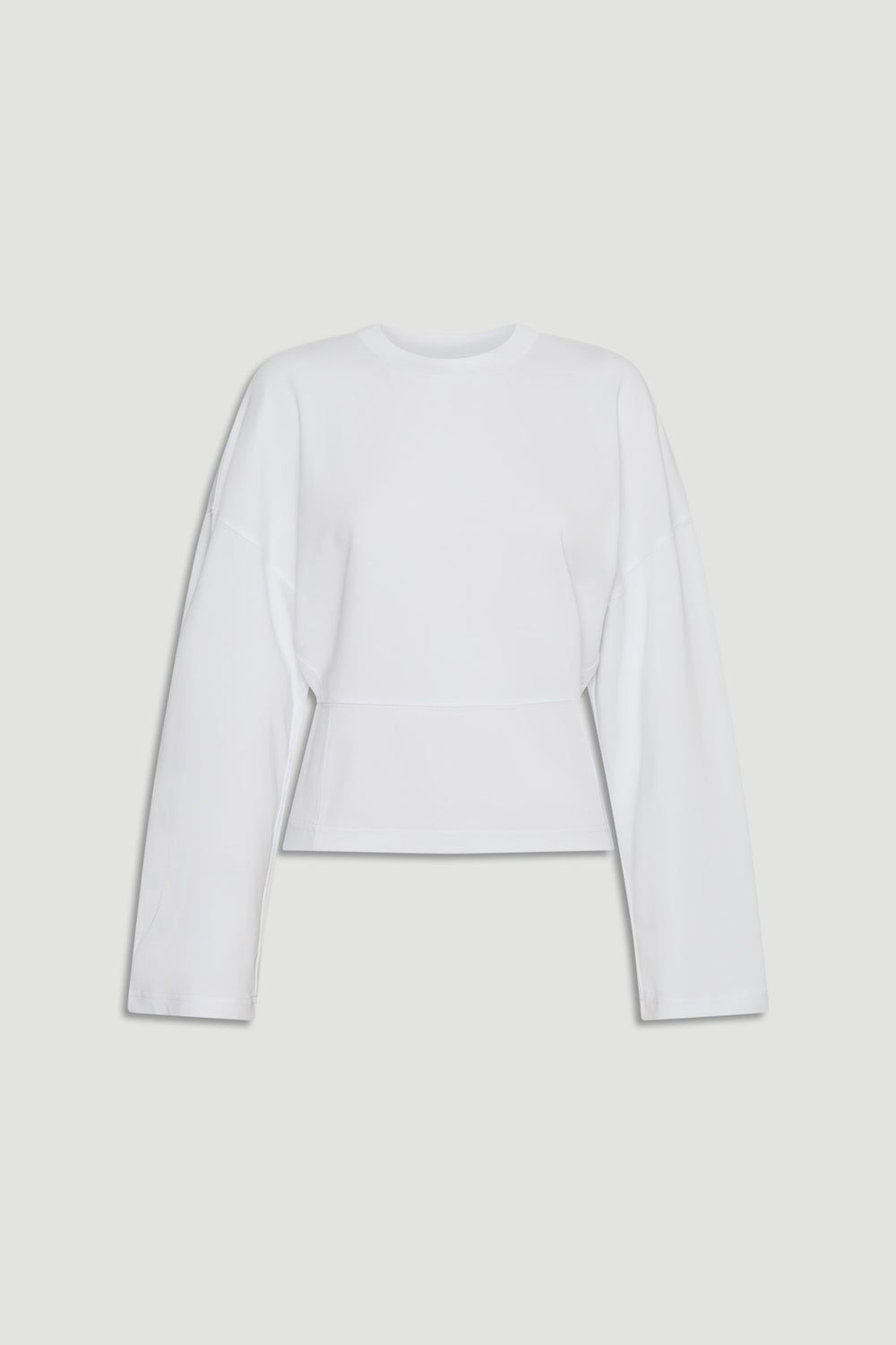 Minimalist white long sleeve top with dropped shoulders and a slightly tapered waist for a modern silhouette
