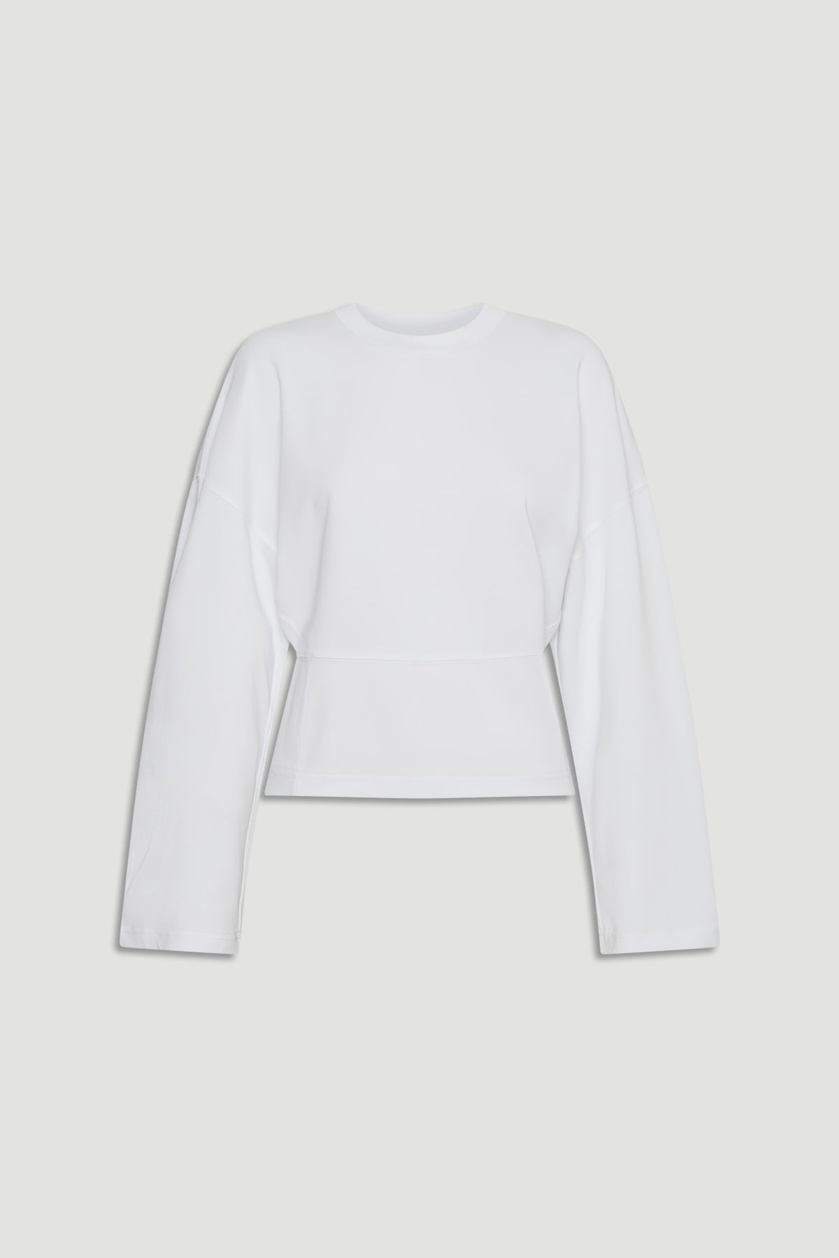 Minimalist white long sleeve top with dropped shoulders and a slightly tapered waist for a modern silhouette