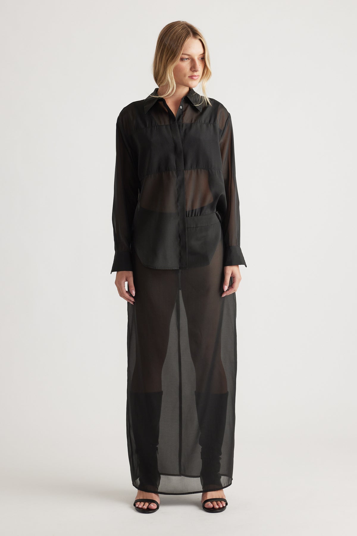 Front view of a black sheer organza long shirt with a classic collar, long sleeves, and a flowing silhouette