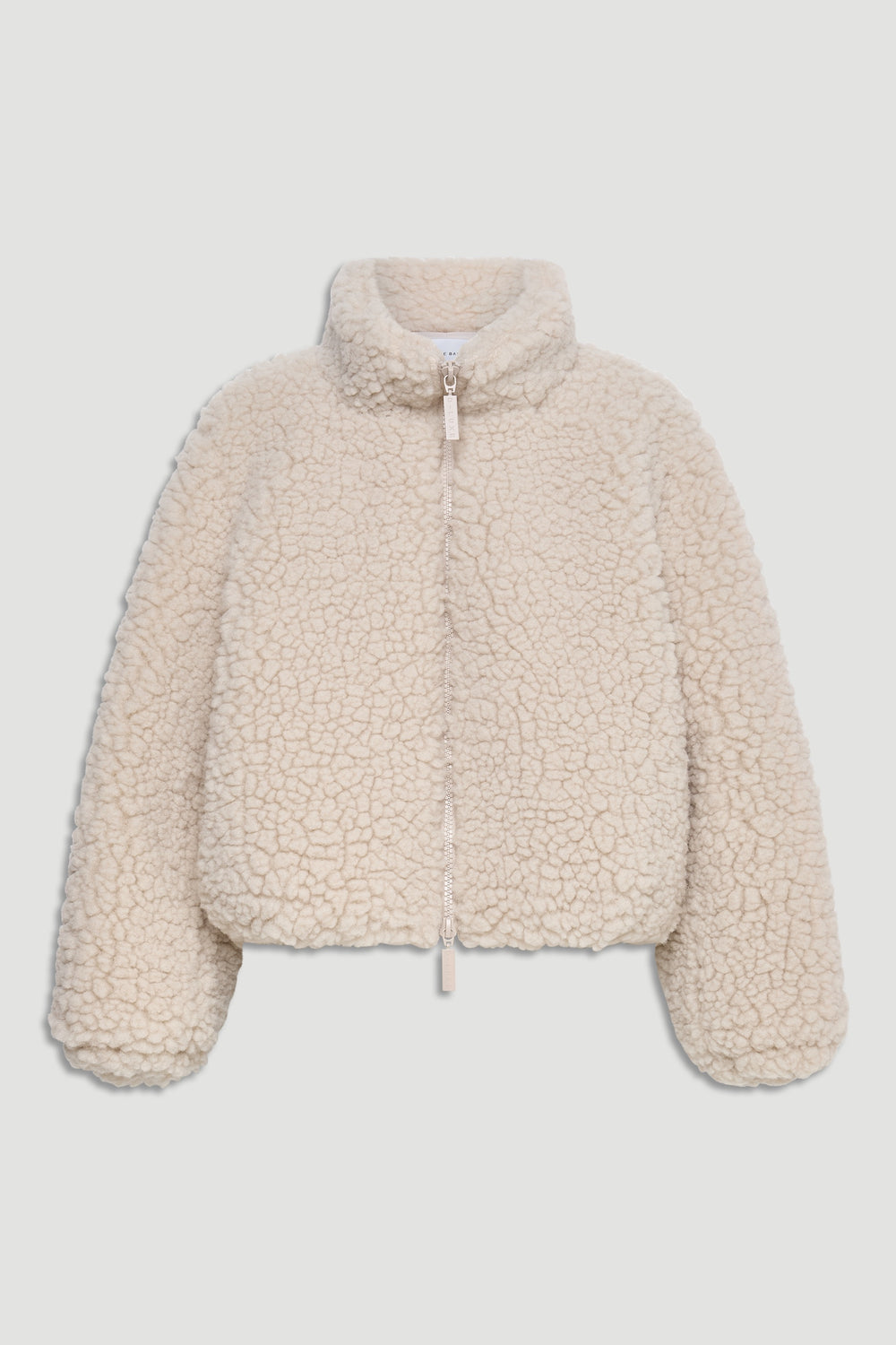 Cream-colored sherpa bomber jacket with high neck, full zipper, and relaxed fit for cozy layering.