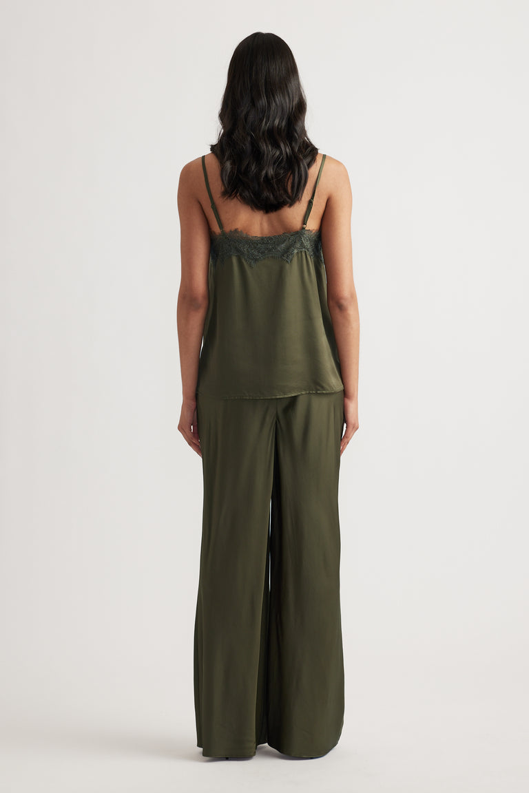 Woman wearing an olive lace-trimmed cami with matching wide-leg pants, shown from the back against a neutral background