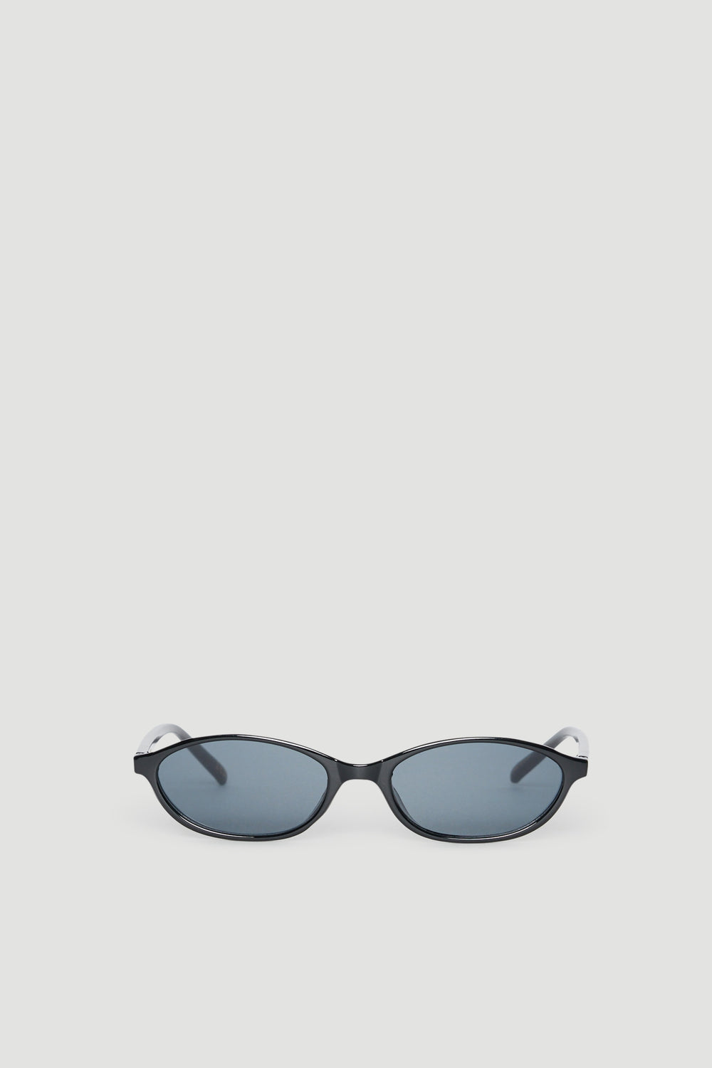 Slim black cat eye sunglasses with tinted lenses providing 100% UV protection on a neutral background
