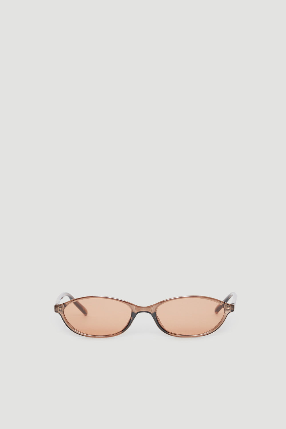 Slim cat eye sunglasses with tinted lenses offering 100% UV protection in a sleek, modern frame design.