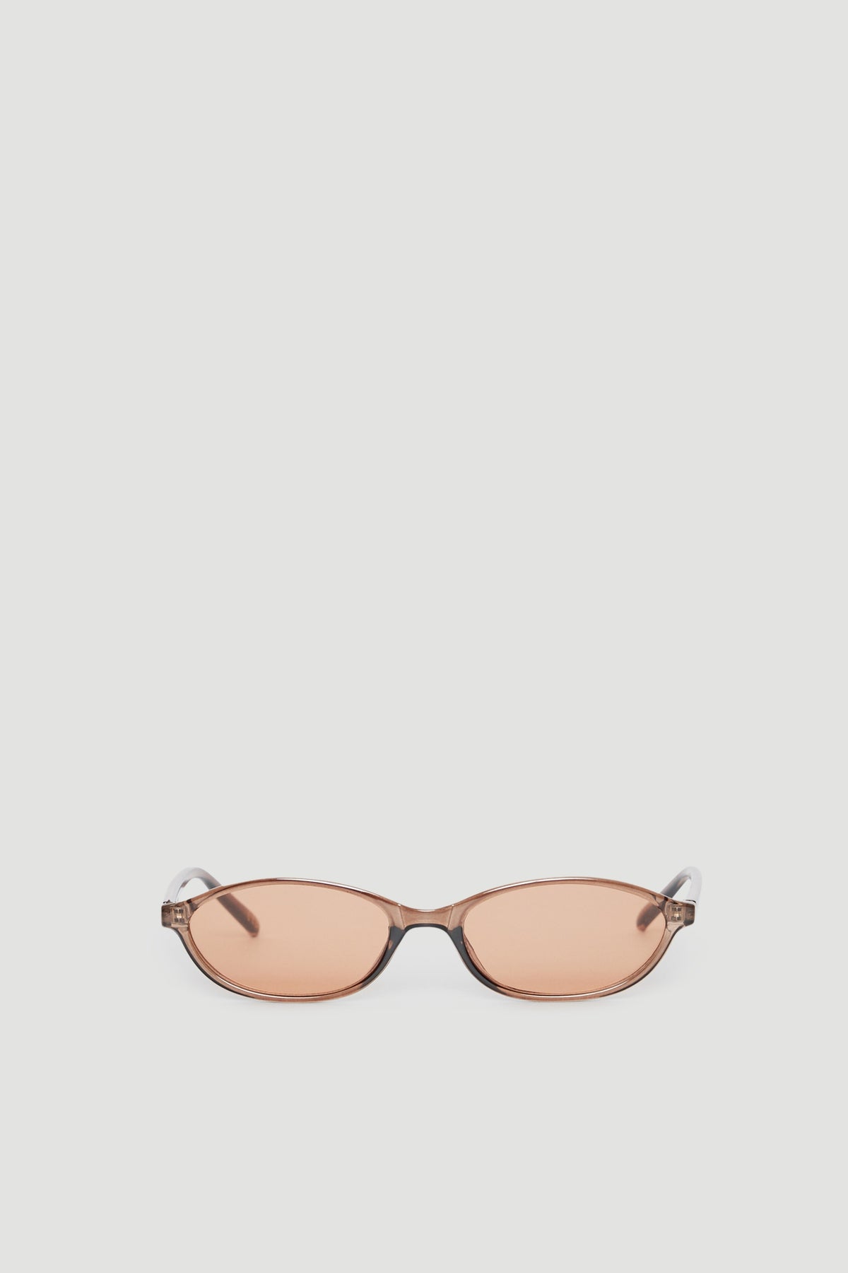 Slim cat eye sunglasses with tinted lenses offering 100% UV protection in a sleek, modern frame design.