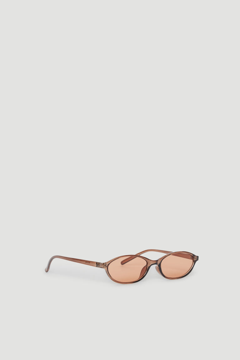 Slim frame sunglasses with tinted lenses and a subtle cat eye shape offering stylish UV protection.