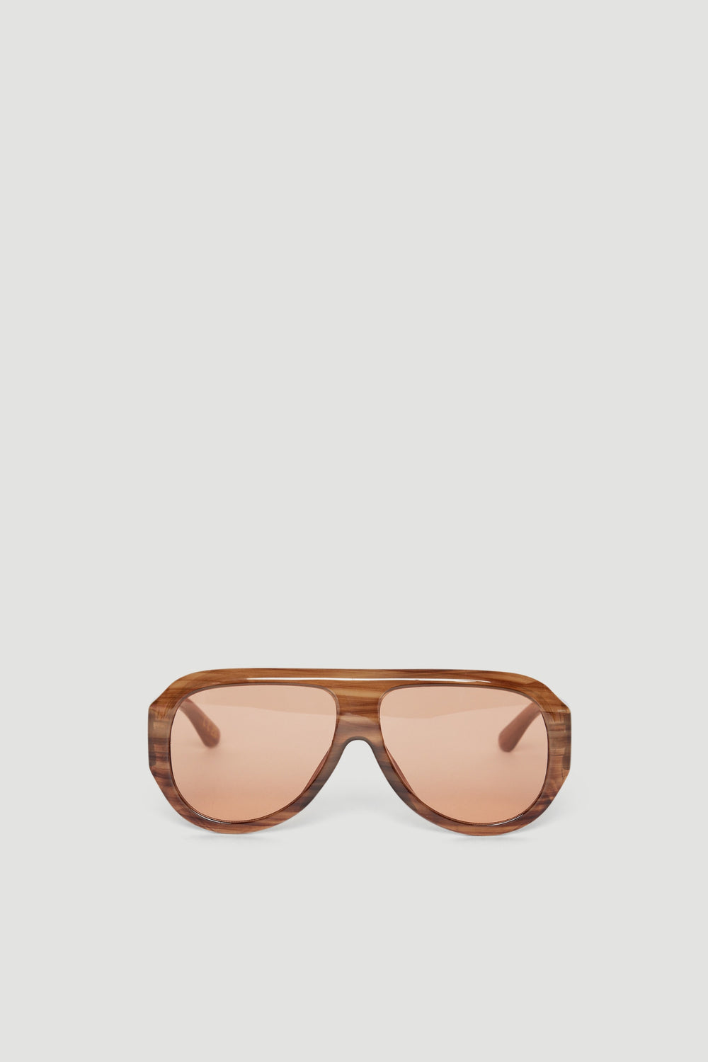 Aviator-style sunglasses with oversized tinted lenses and a textured brown frame against a neutral background
