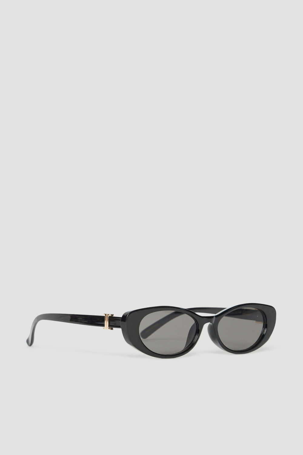 Black oval sunglasses with gold accents and tinted lenses