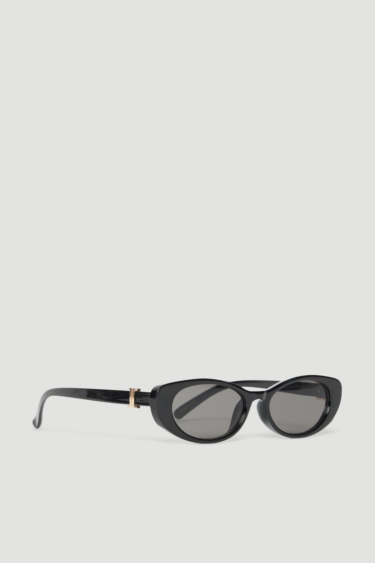 Black oval sunglasses with gold accents and tinted lenses