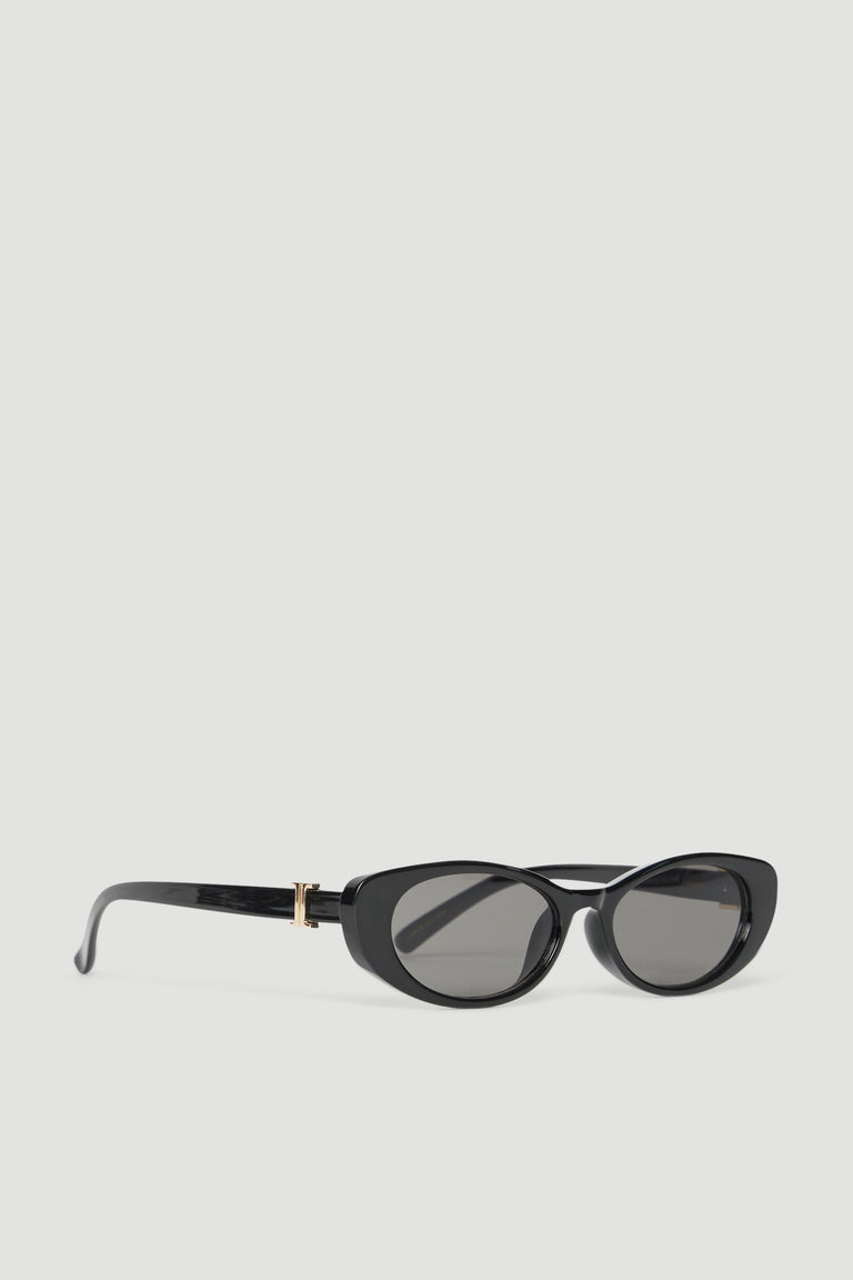Black oval sunglasses with gold accents and tinted lenses