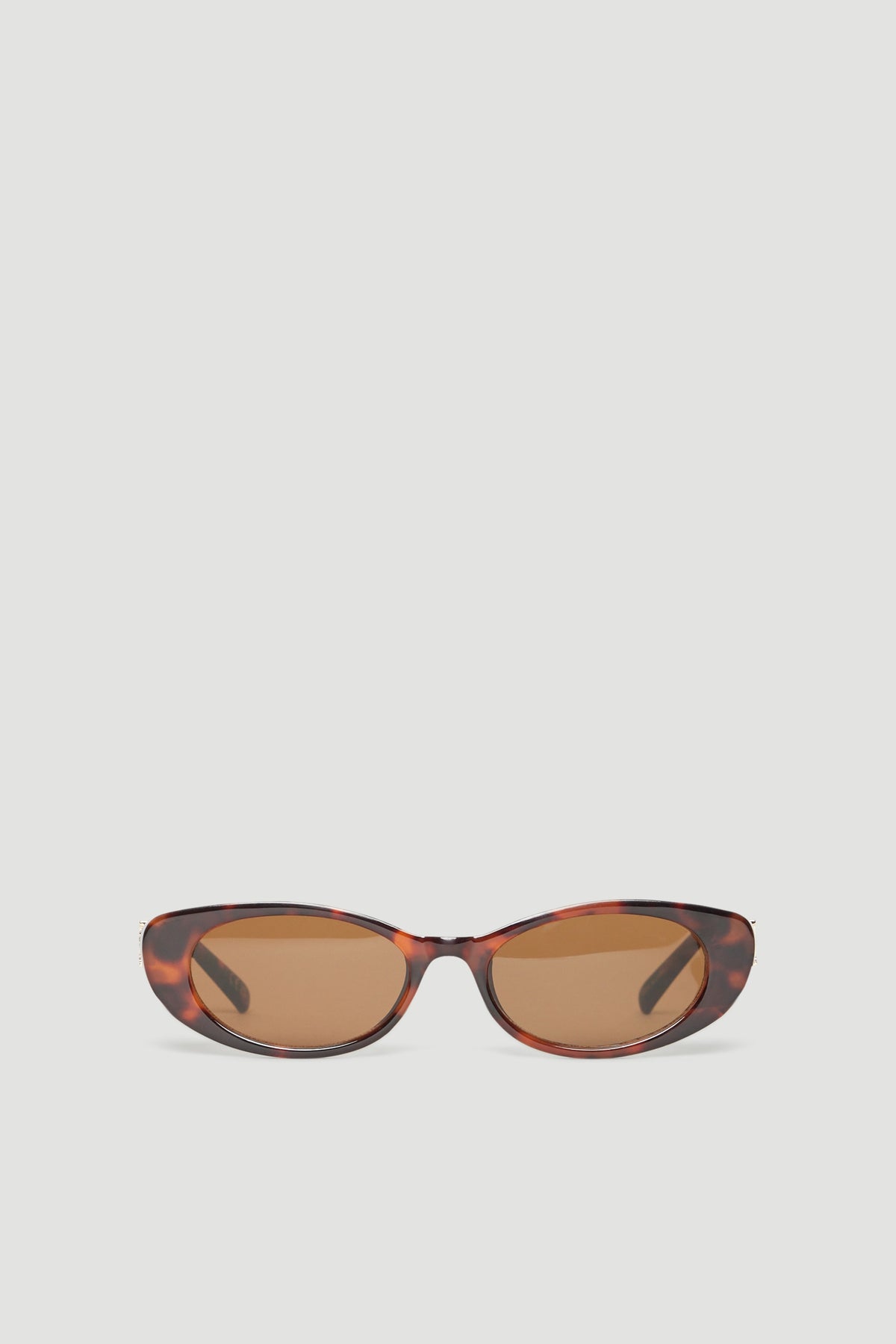 Tortoiseshell oval sunglasses with gold accents and tinted lenses