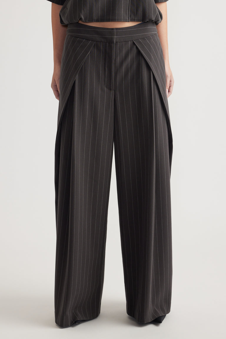 Front view of high-rise wide leg pinstripe pants with pleat details and soft drape on the model