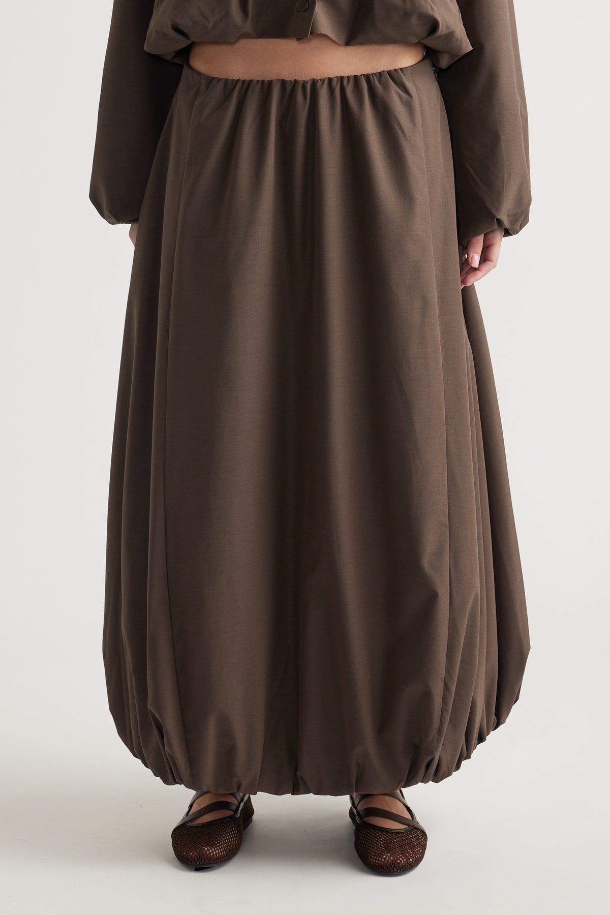 Brown midi skirt with bubble hem detail, relaxed fit, and elastic waistband for an effortless, casual look.