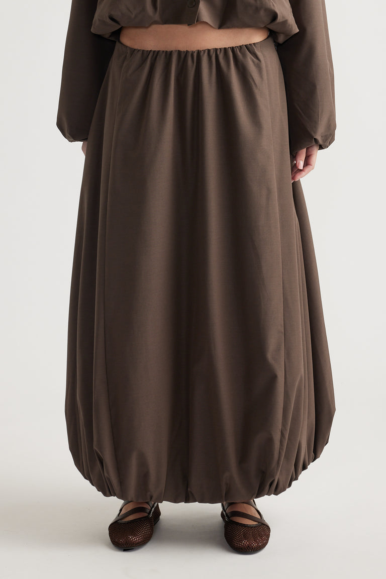 Brown midi skirt with bubble hem detail, relaxed fit, and elastic waistband for an effortless, casual look.