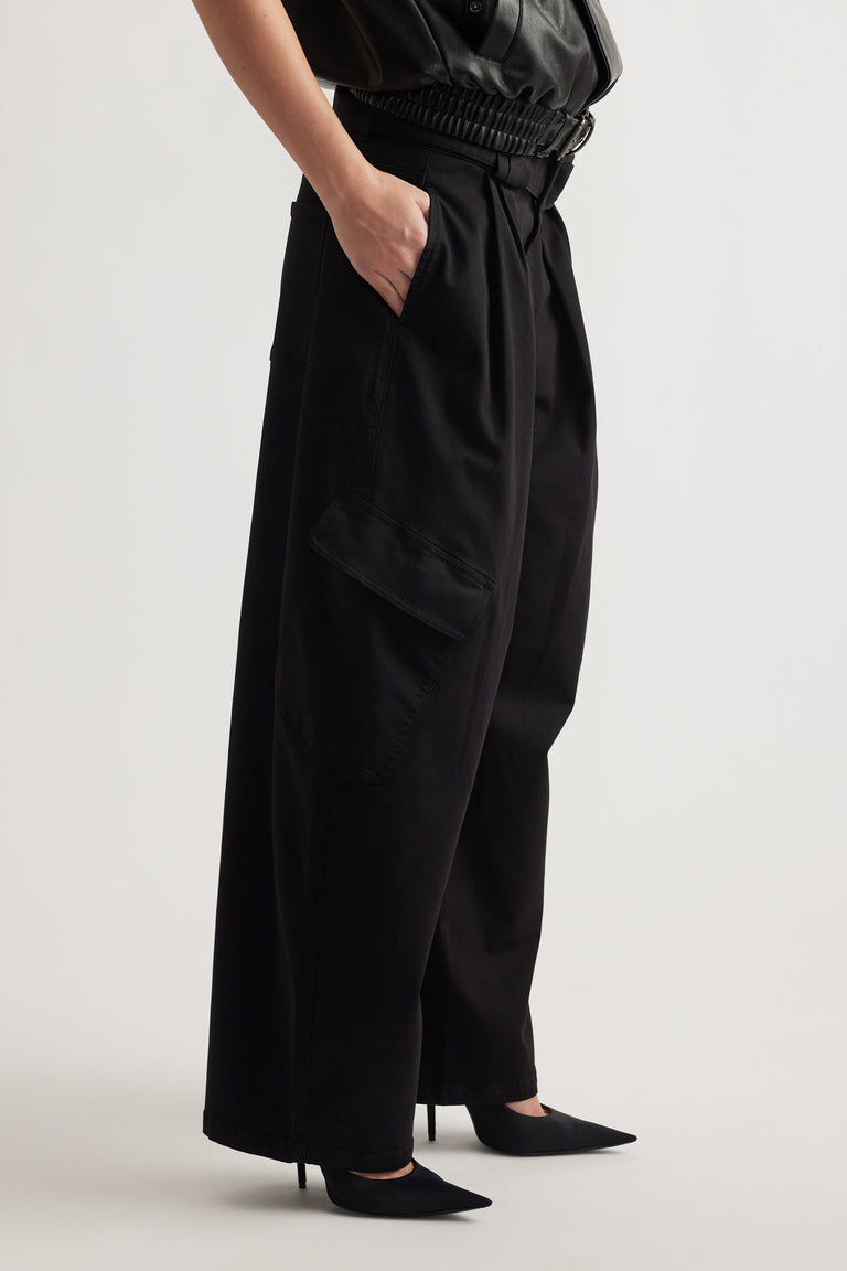Black balloon cargo pants with side flap pocket styled with a belted waist and pointed heels