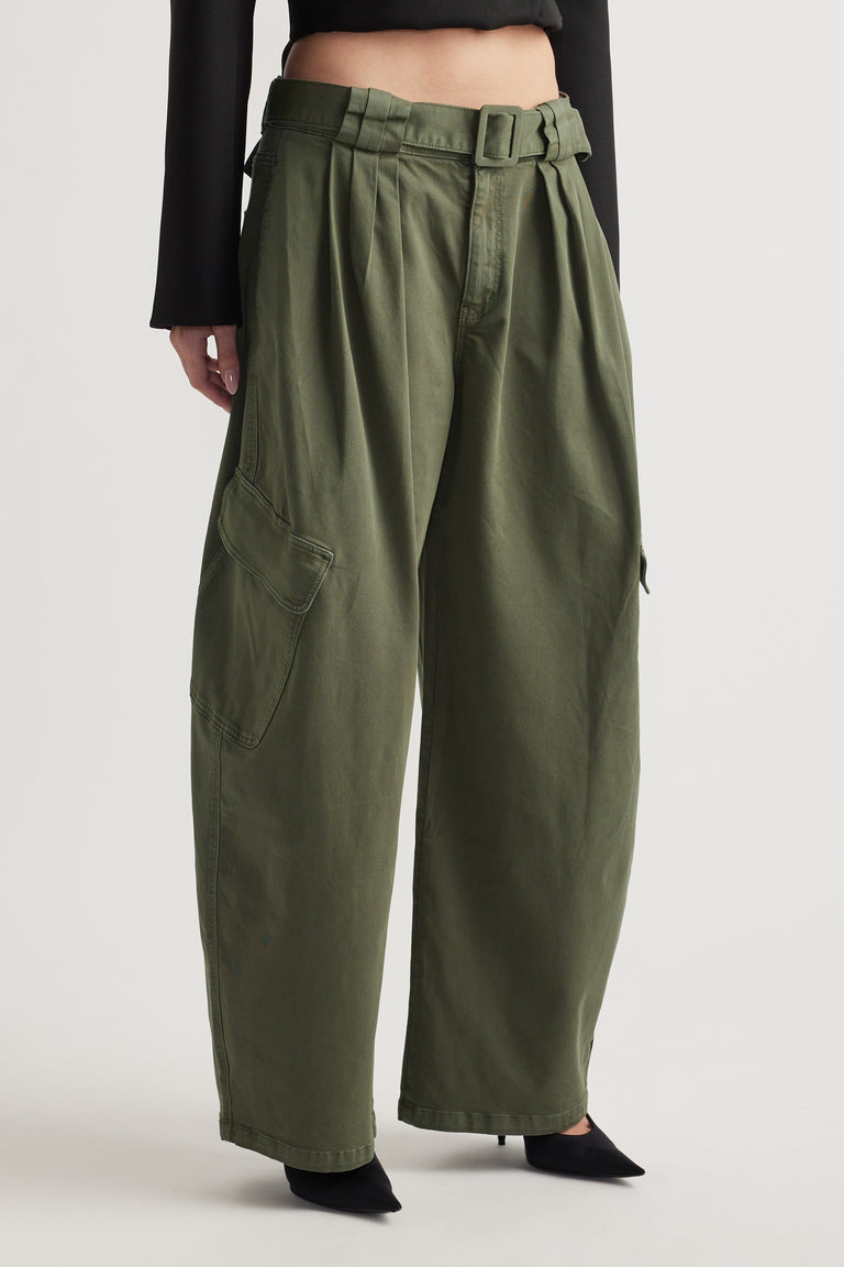 Wide-leg dark olive pants with cargo pockets and a belted waist paired with black pointed shoes and cropped top