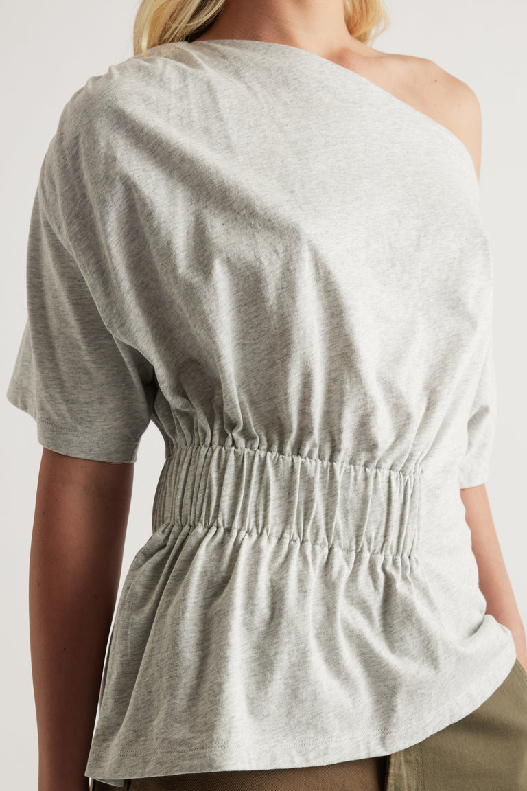 Grey asymmetrical short sleeve top with a one shoulder neckline and elastic cinched waist