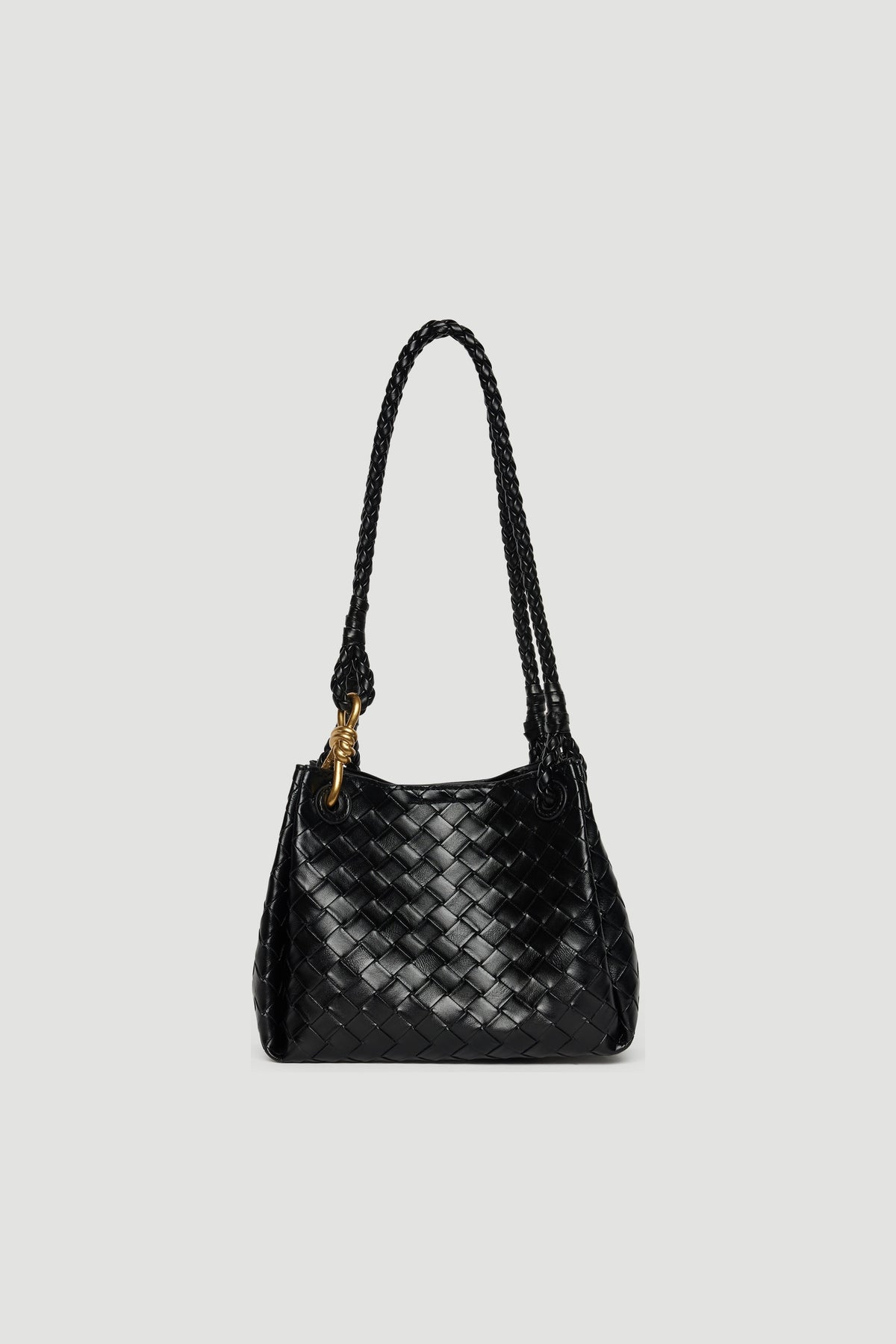 Black medium shoulder bag featuring woven texture, braided straps, and gold-toned hardware closure against a plain background