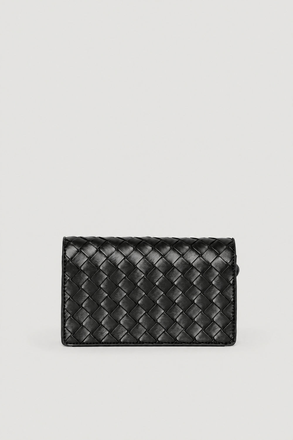 Black woven crossbody bag with a textured finish and flap clasp closure