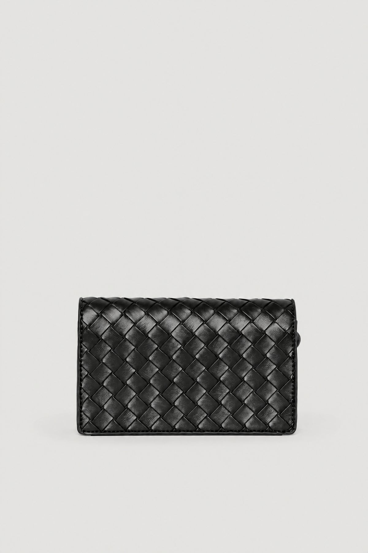 Black woven crossbody bag with a textured finish and flap clasp closure