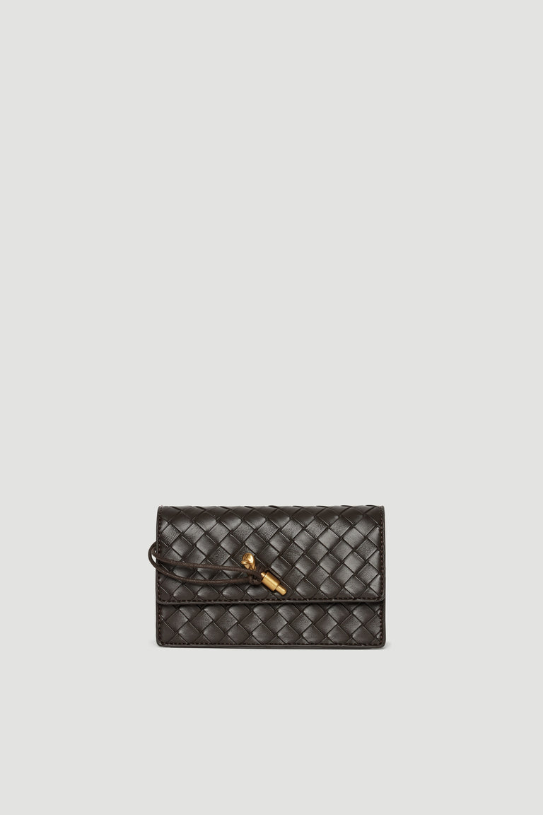 Small dark brown crossbody bag with woven texture and gold clasp closure on plain background