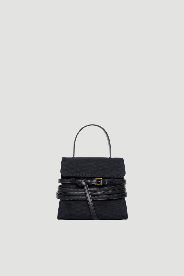 Black structured handbag with leather belt buckle detail and top handle on plain background