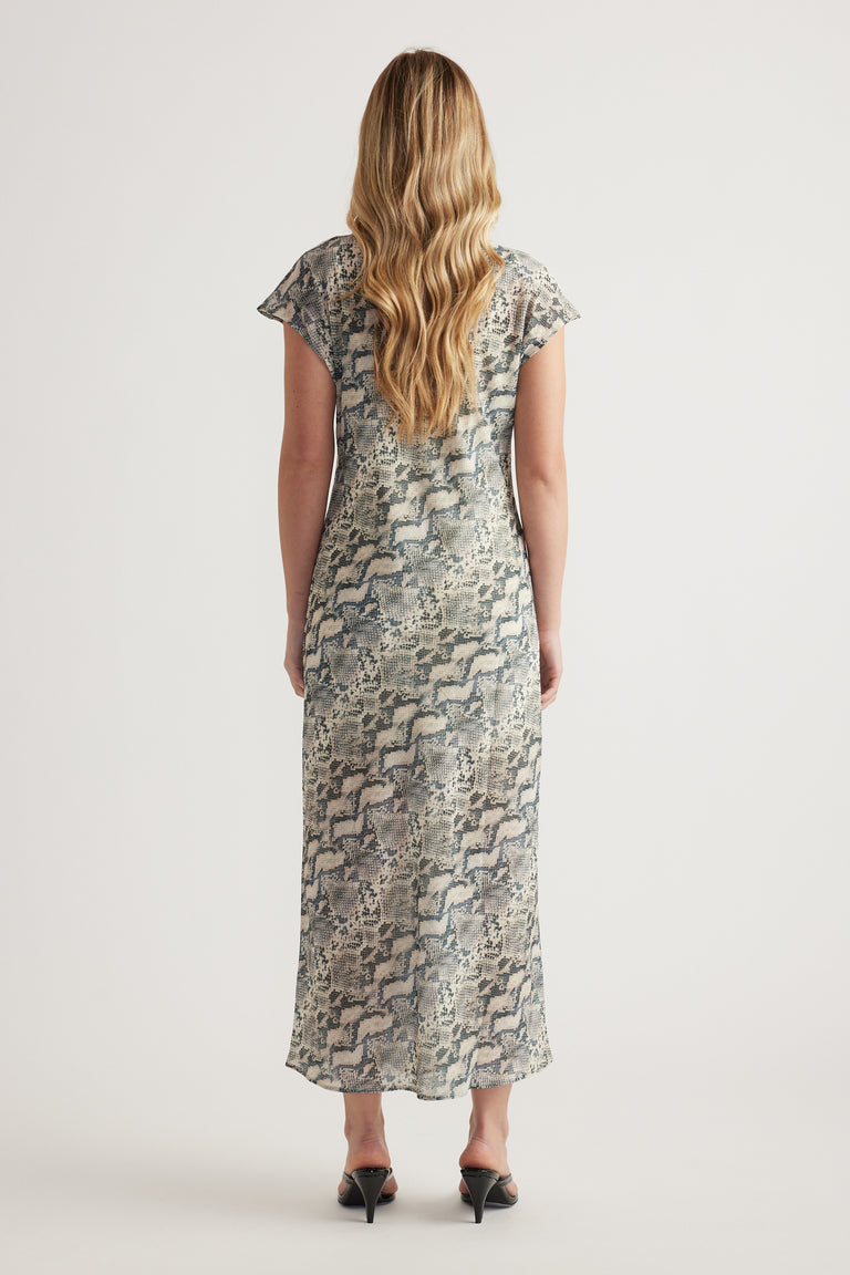 Woman wearing a snakeskin print midi dress with short sleeves and black heels