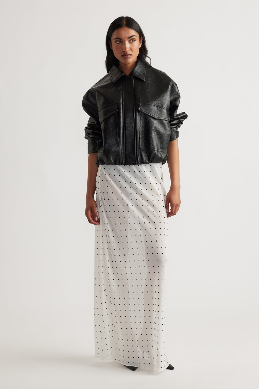 Model wearing Faye Sheer Maxi Skirt in portrait view, gallery position 1, featuring sheer fabric with small dot pattern.