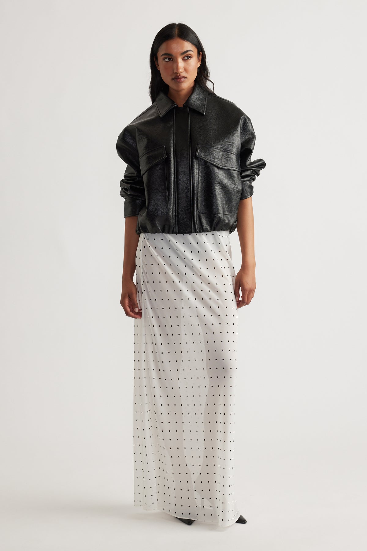Model wearing Faye Sheer Maxi Skirt in portrait view, gallery position 1, featuring sheer fabric with small dot pattern.