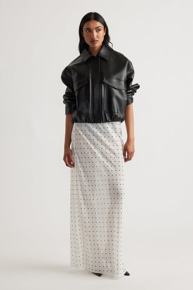 Model wearing Faye Sheer Maxi Skirt in portrait view, gallery position 1, featuring sheer fabric with small dot pattern.
