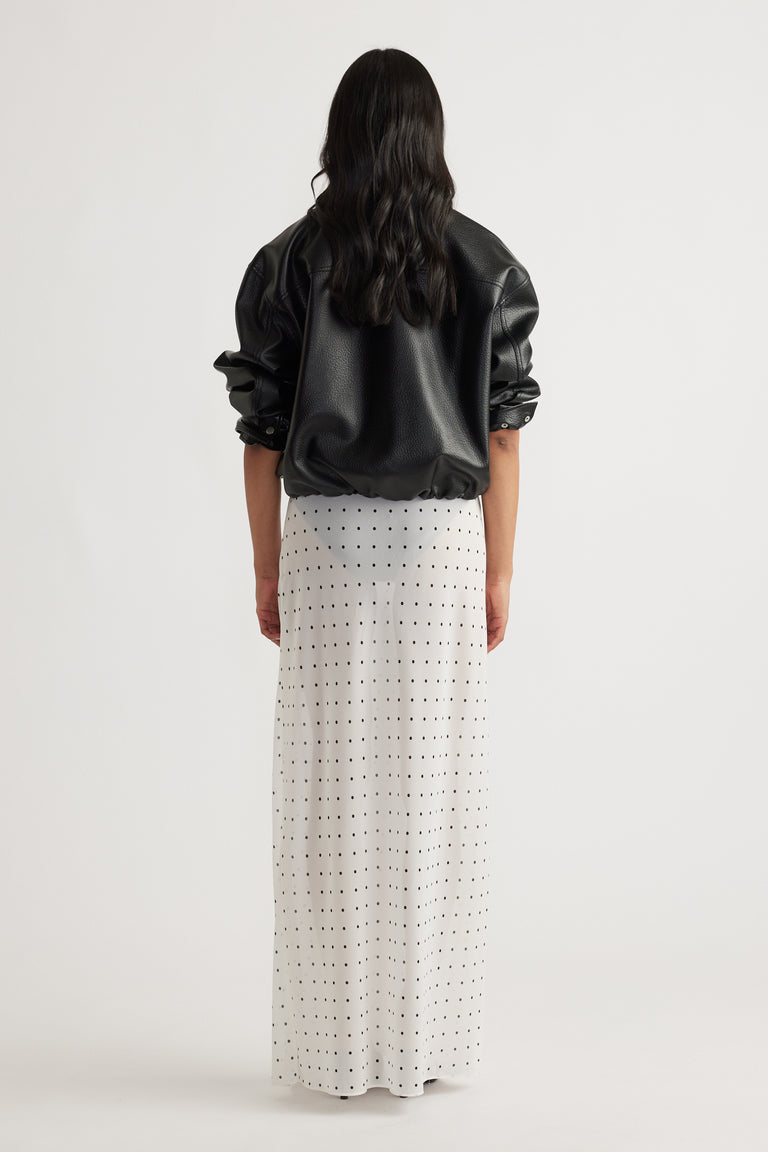 Back view of model wearing Faye Sheer Maxi Skirt with black polka dots in portrait gallery position 3, 1600x2400 size.