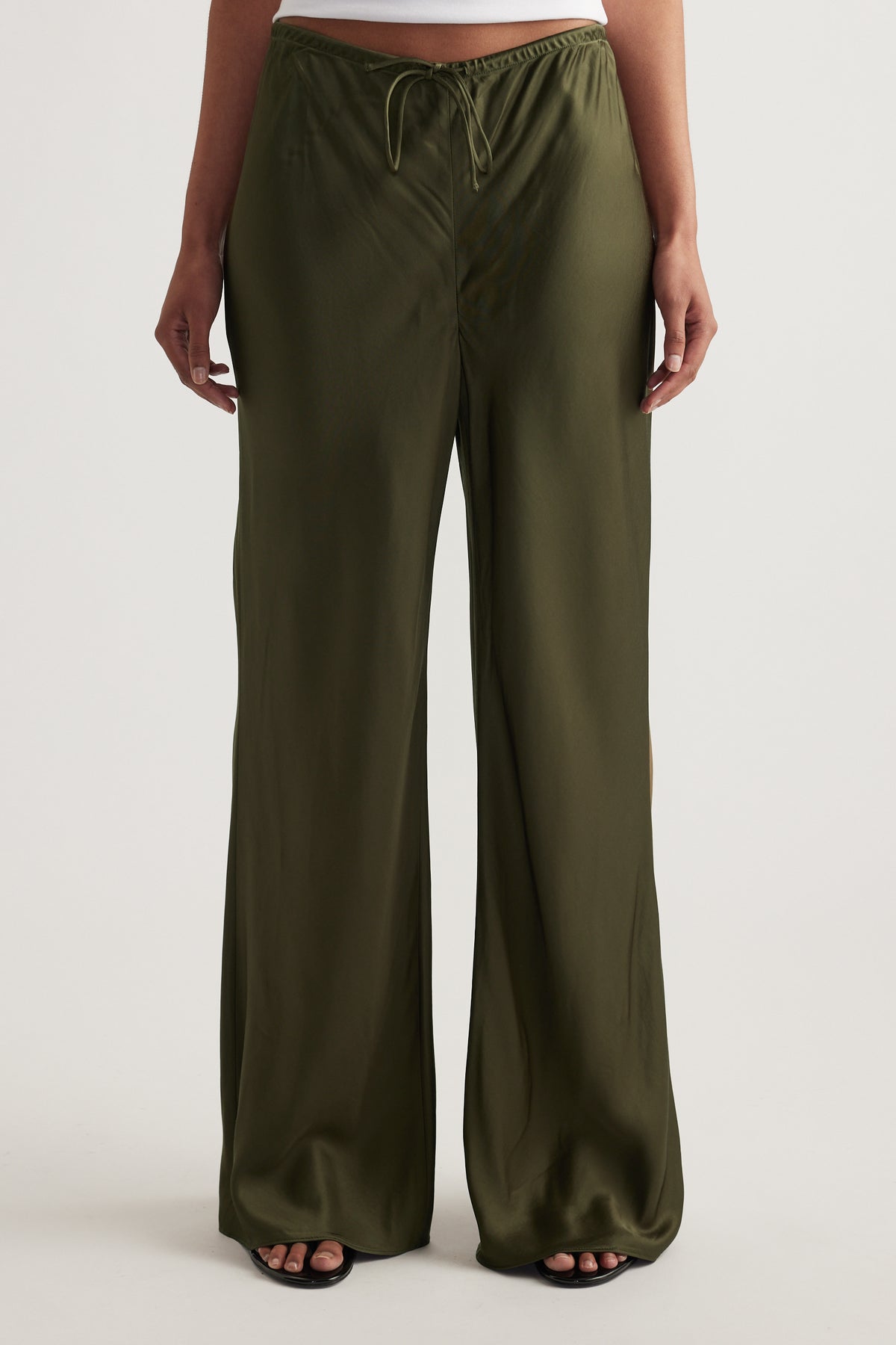 Model wearing olive green full length pants with an elastic drawcord waist and straight leg fit