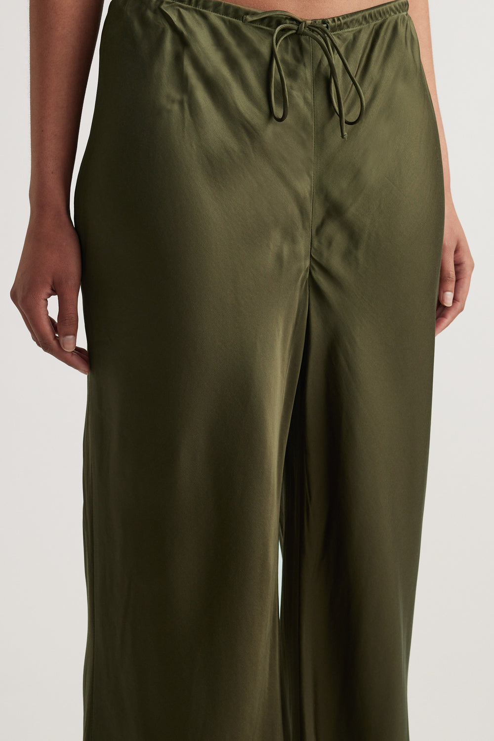 Olive green bias cut pants with an elastic drawcord waist and full length straight legs