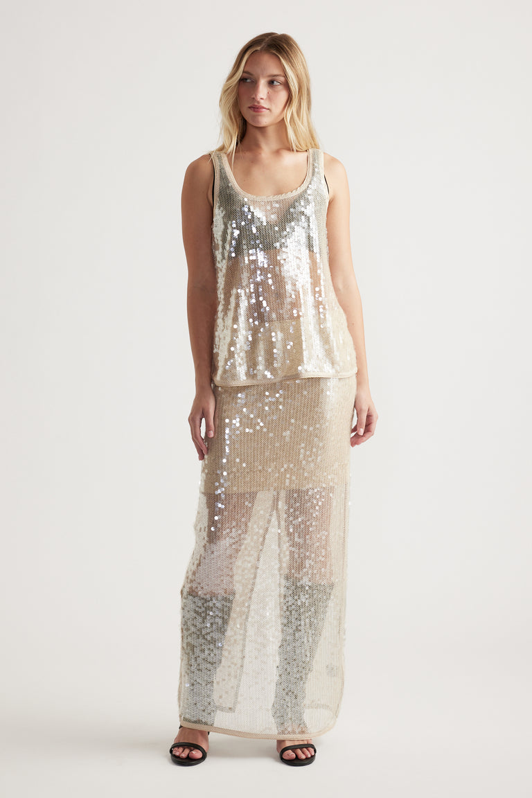 Sleeveless champagne sequin tank with a relaxed fit, styled for a shimmering and elegant daytime look.