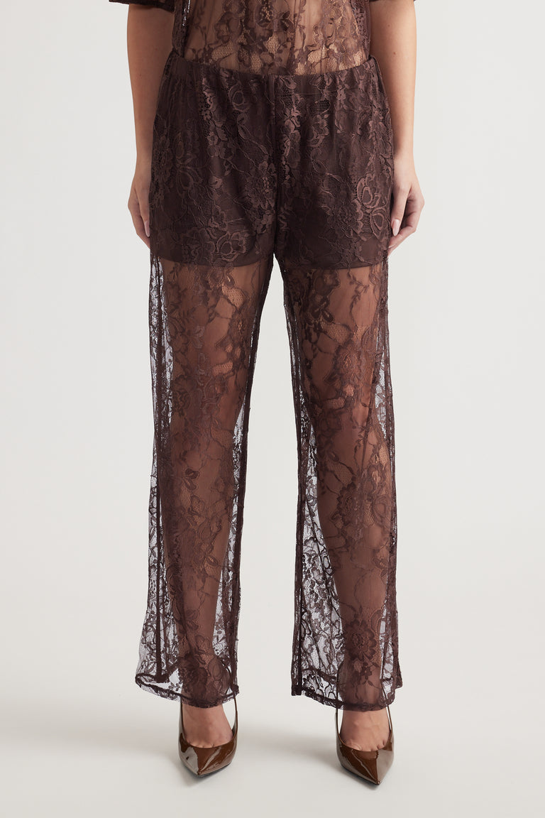 Wide-leg high-rise lace pants with detachable lining and floral pattern worn with brown pointed heels