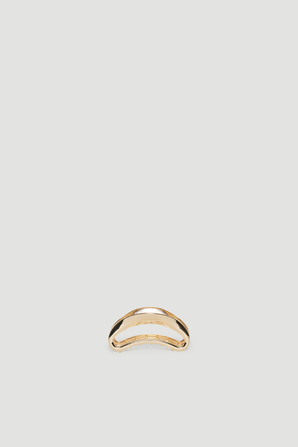 Minimalist gold hair claw with a smooth, curved design perfect for elegant everyday styling
