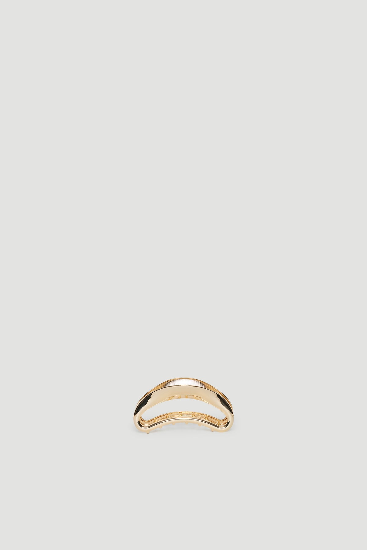 Minimalist gold hair claw with a smooth, curved design perfect for elegant everyday styling