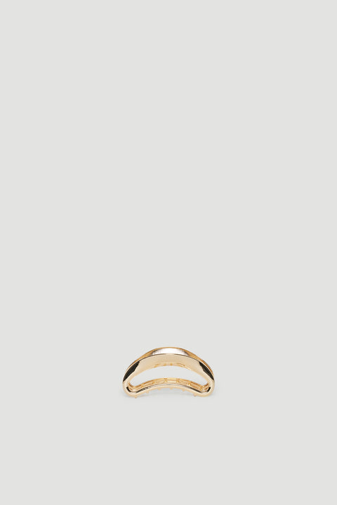 Minimalist gold hair claw with a smooth, curved design perfect for elegant everyday styling