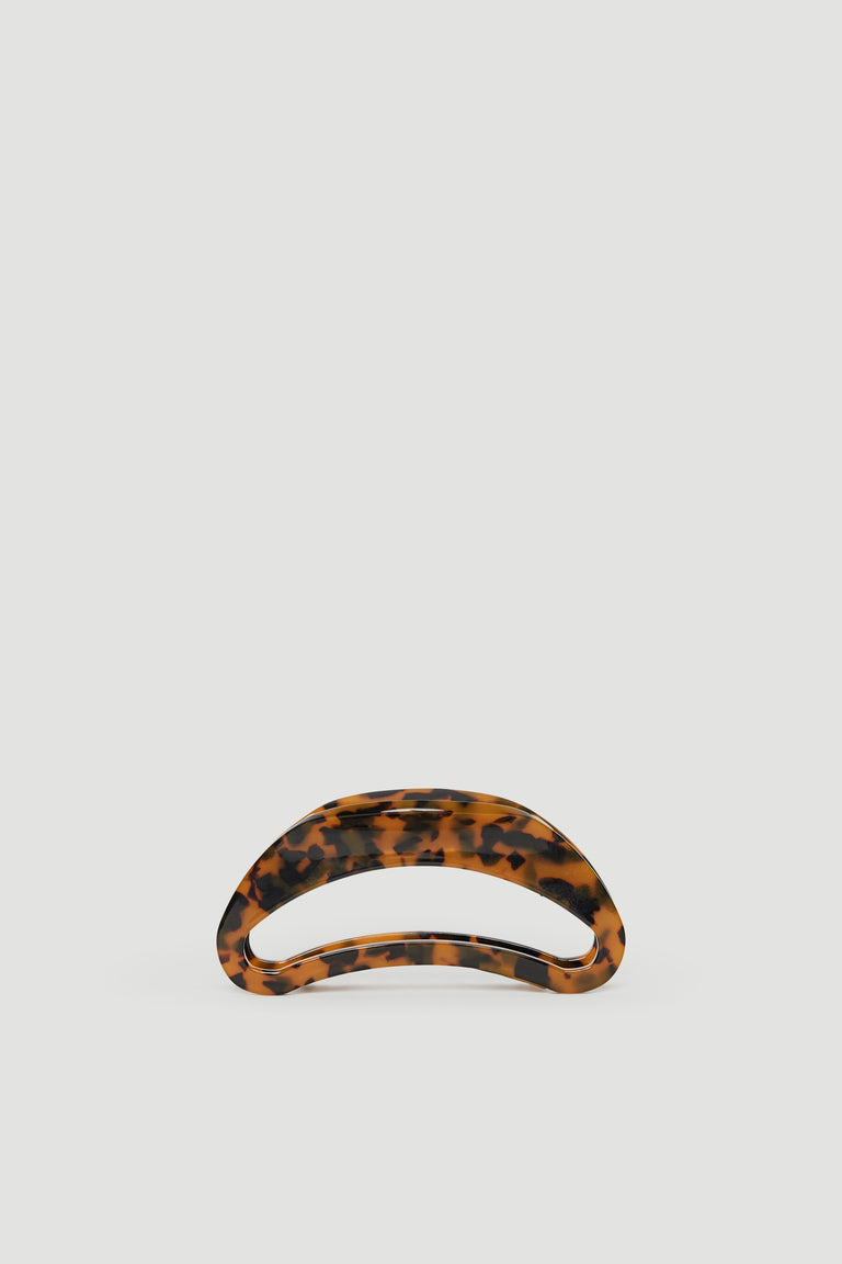 Tortoiseshell hair claw with a sleek curved design, perfect for stylish everyday hair styling.