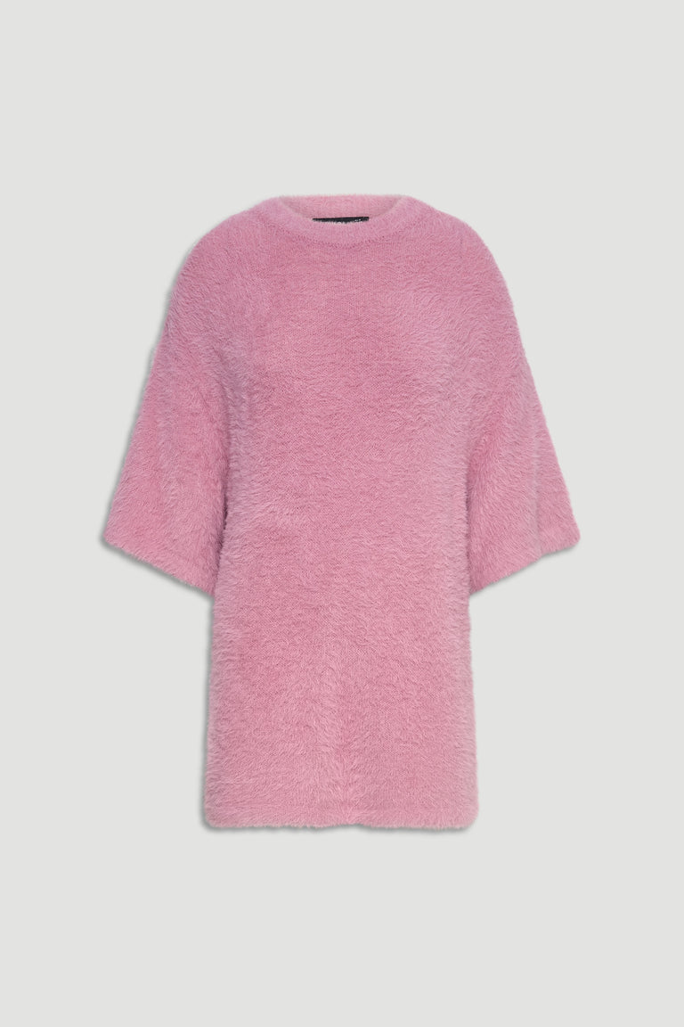 Soft oversized pink knit tee with a fuzzy texture and relaxed elbow-length sleeves for effortless comfort.