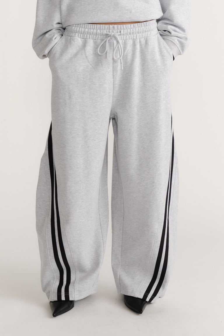 Light grey wide-leg trackpants with black side stripes and an adjustable drawstring waist for laid-back style