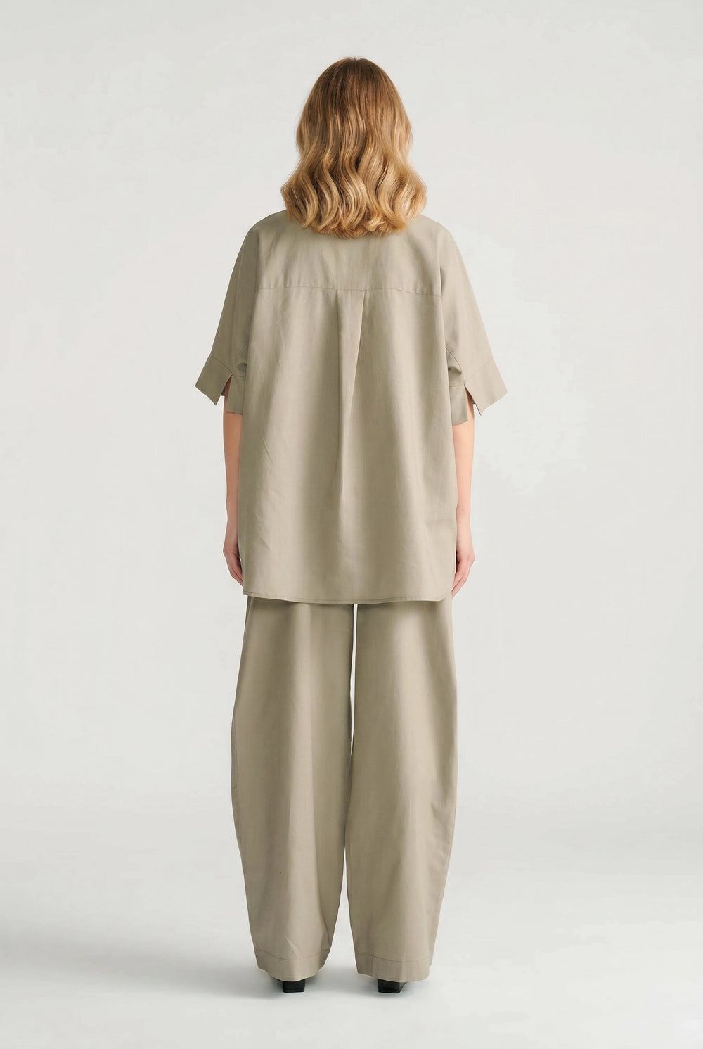 Back view of a relaxed fit sage oversized shirt paired with matching wide-leg pants for effortless style.