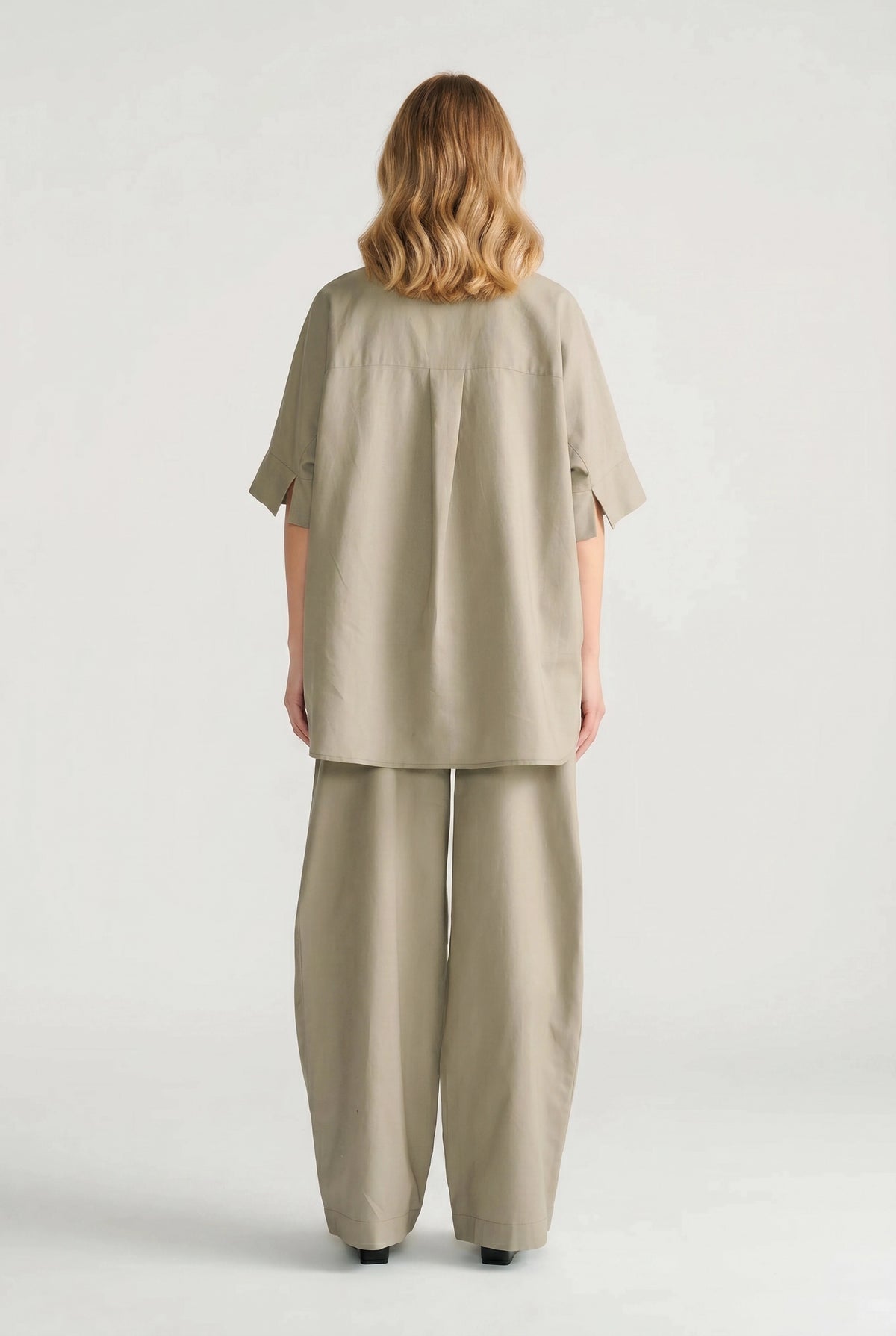 Back view of a relaxed fit sage oversized shirt paired with matching wide-leg pants for effortless style.