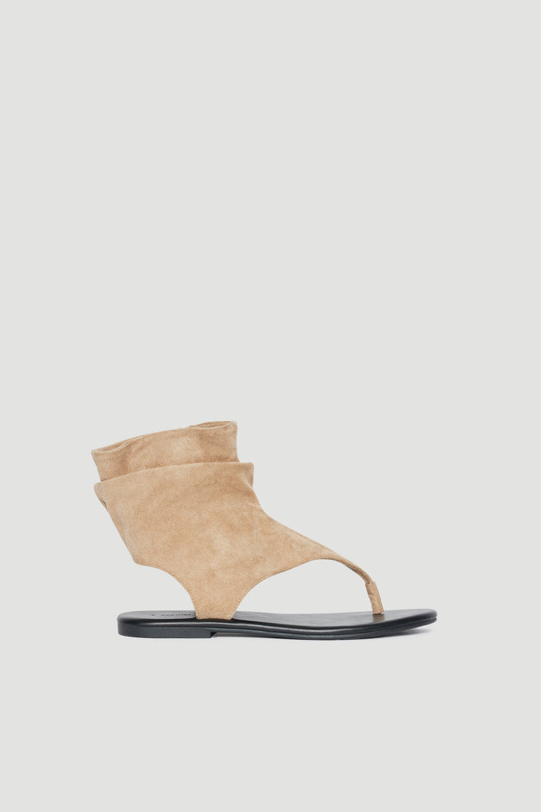 Tan slouchy thong sandal with micro suede upper, toe post and flat black sole